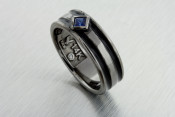 14k black rhodium ring with a princess cut blue sapphire